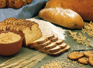 A variety of whole grain breads on a table.