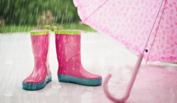 Rain boots, umbrella and falling rain.