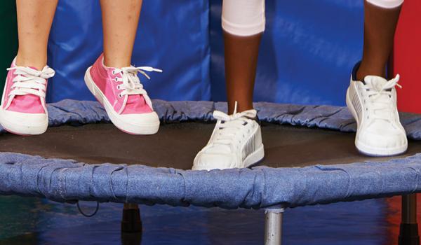 Children's feet jumping on a trampoline