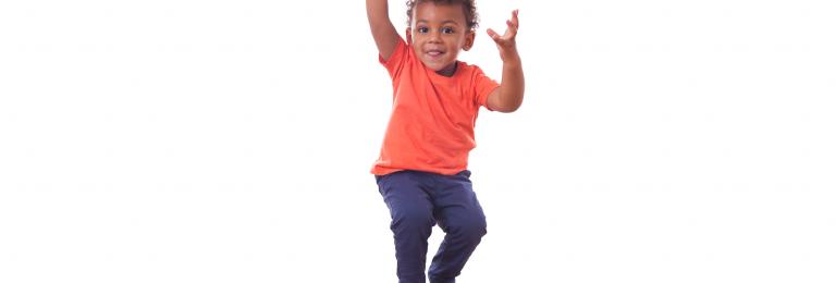 Child jumping in the air and twisting.